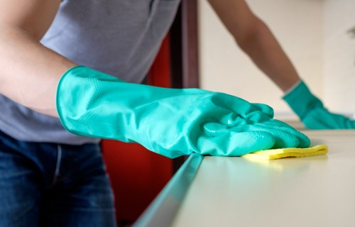 Professional cleaner working in a N7 kitchen during a regular home cleaning visit